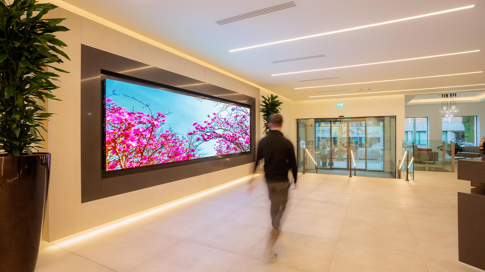 Building reception with wide videowall and passr-by